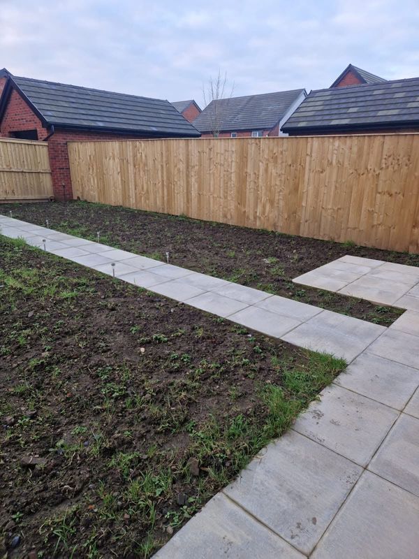 New garden with paved path and fencing