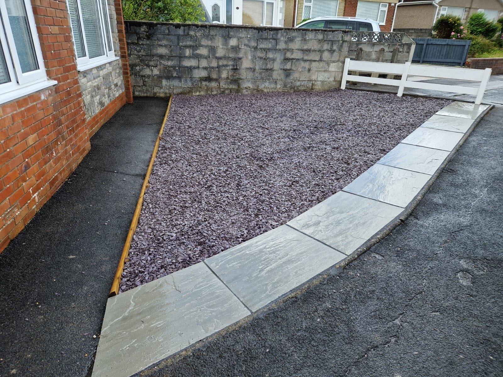 Slate chipping bed with sandstone edging alongside a new tarmac path